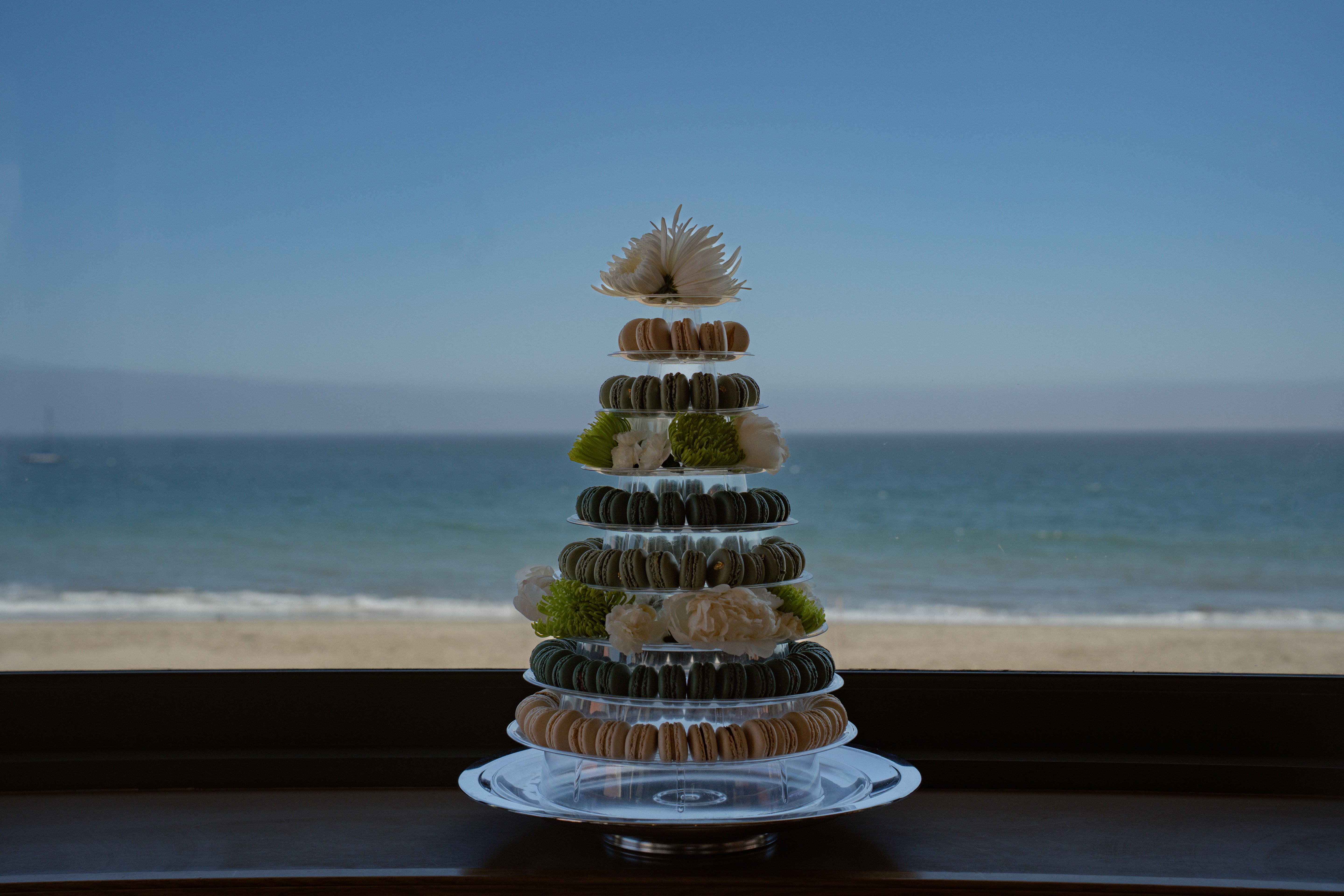 Decorative tower of macarons on a stand with ocean view