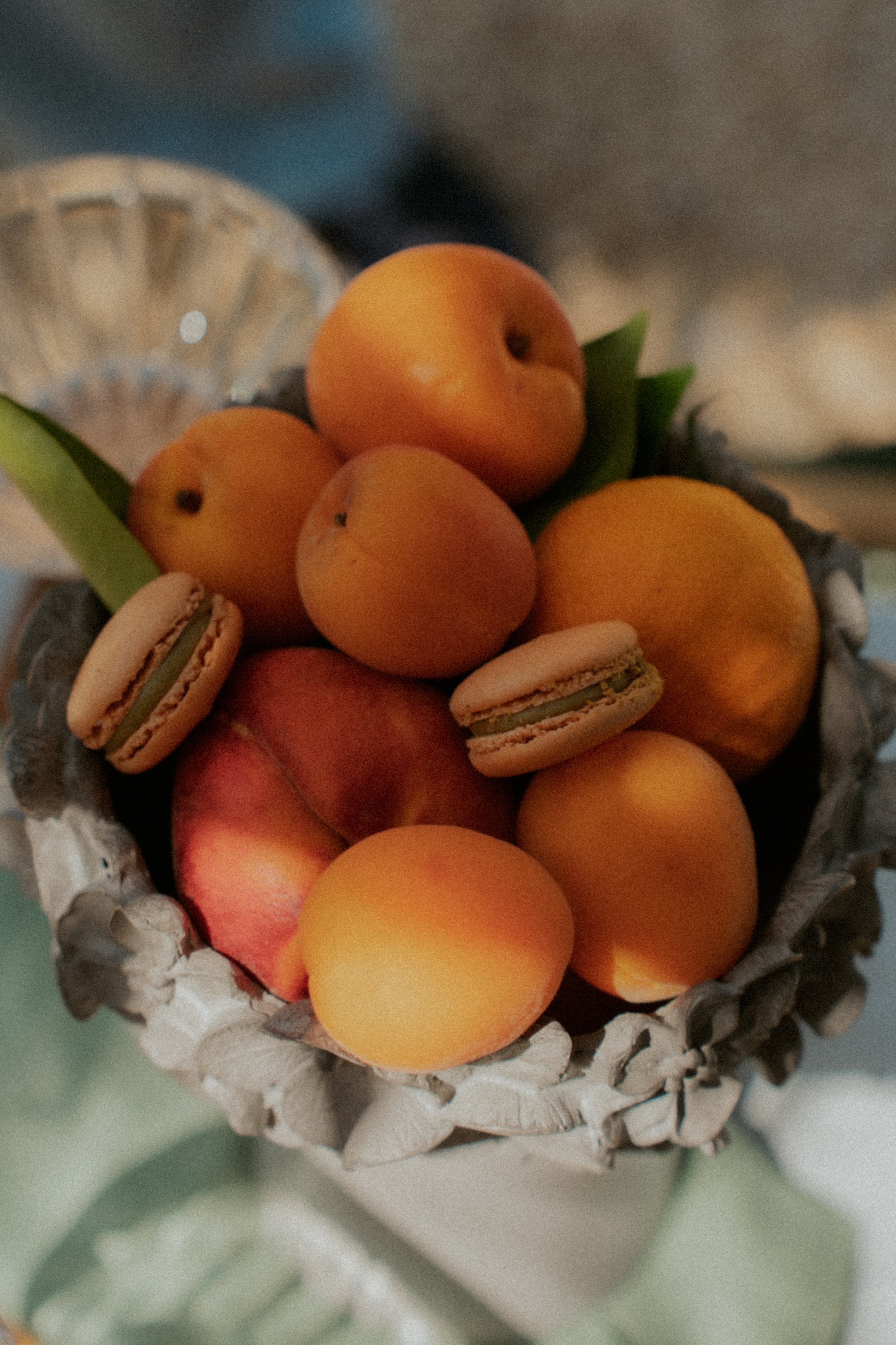 Basket of apricots with macarons on a blurred background