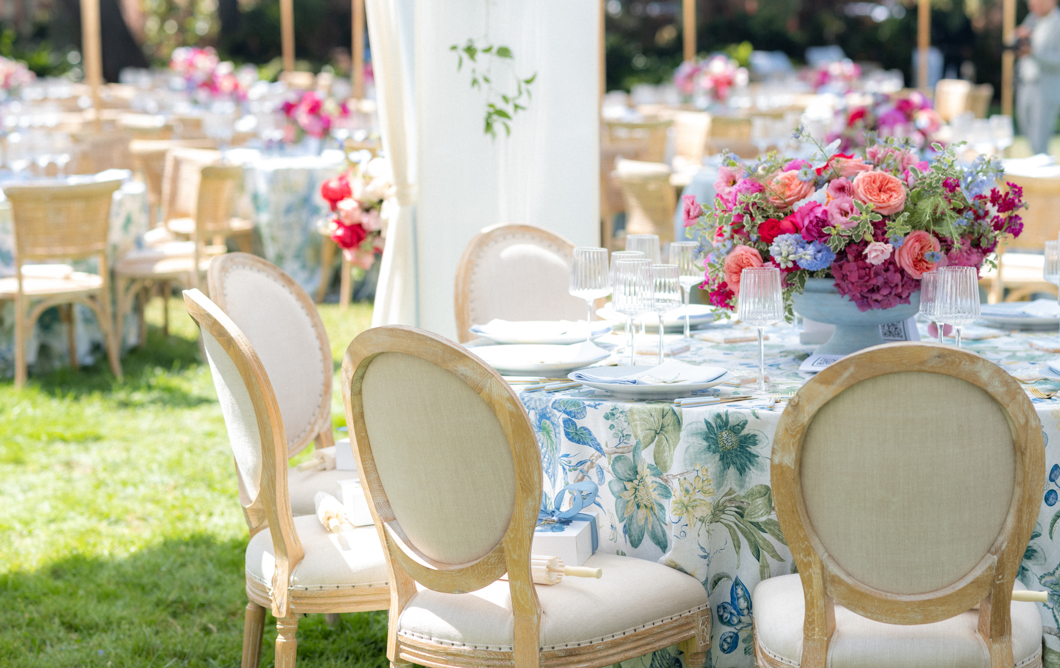 Decorated outdoor wedding reception with floral centerpieces and chairs. Lotusland Gala. Photos by Elizabeth Messina